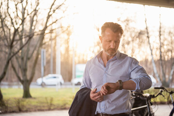 Portrait of mature man checking the time