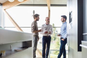 Three businessmen talking during coffee break