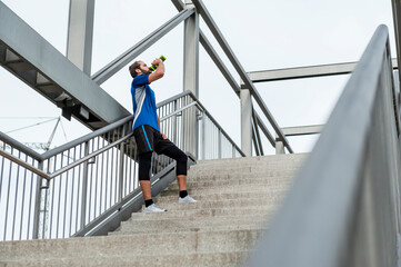 Man on stairs having a break from running