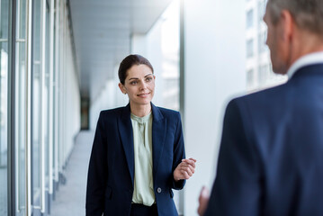 Portrait of smiling businesswoman listening to business partner