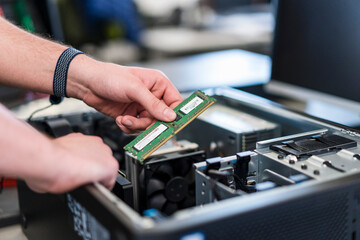 Close-up of teenager assembling personal computer