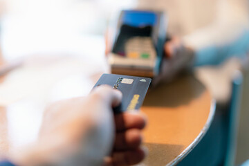 Man using credit card reader, close-up