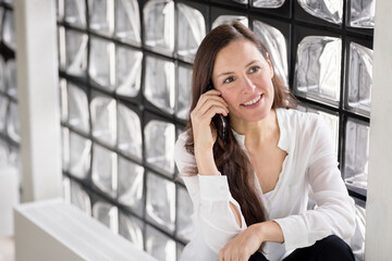 Portrait of smiling businesswoman on the phone