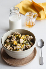 Bowl of semolina pudding with passion fruit and oat flake crumble