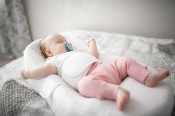 Cute baby girl sleeping on the bed