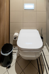 White ceramic toilet bowl with the lid closed