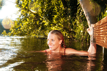Happy young woman in a lake