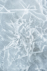 Background frozen water with fancy patterns. Ice texture. Cracks and bubbles inside frozen water.