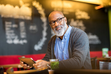 Portrait of man with tablet in a coffee shop