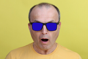 Surprised man in blue glasses.