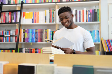 Joyful student in a university library, surrounded by books, showcasing intelligence and a love for learning.