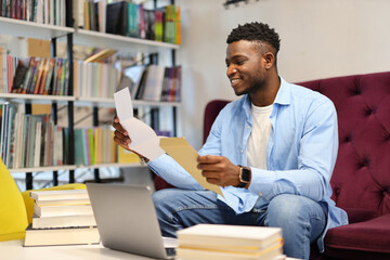 Young academic man reading, studying with a laptop, blending education and business.