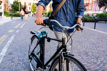 Man pushing a bicycle in the city