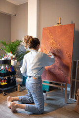 Young woman painting in her atelier