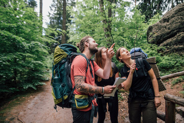 Friends on a hiking trip looking up