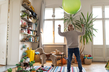 Boy playing with a balloon at home