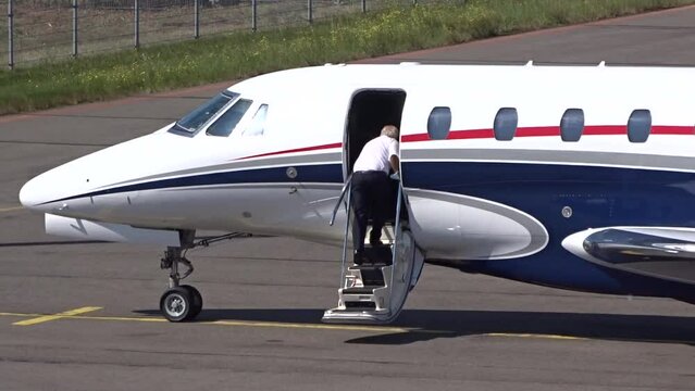 Executive Jet with Pilot boarding the airplane at Small Airport (Business   private jet   corporate jet)