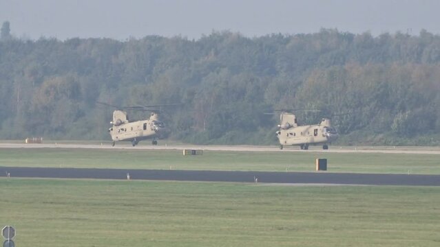 Army Air Force Military Heavy Helicopters Landing at air base after mission.