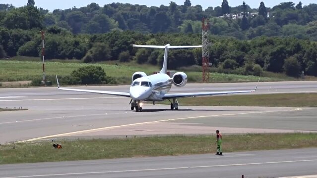 Generic Airplane Turning and Taxiing on the tarmac of airport unmarked white