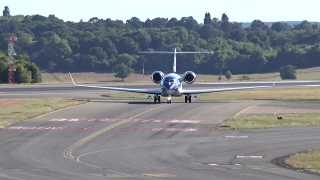 High End Business Corporate Private Jet Airplane Aircraft Taxiing Head On at Executive Airport