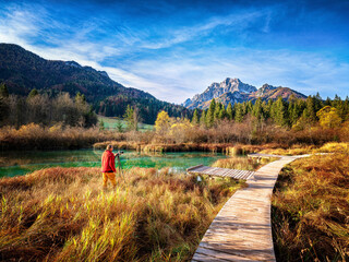 Slovenia, Kranjska Gora, Man photographing scenic landscape of Zelenci Springs - obrazy, fototapety, plakaty