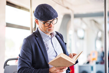 Man in bus reading book