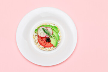 Rice Cake Sandwich with Avocado, Tomato, Cottage Cheese, Olives and Radish on White Plate. Easy...
