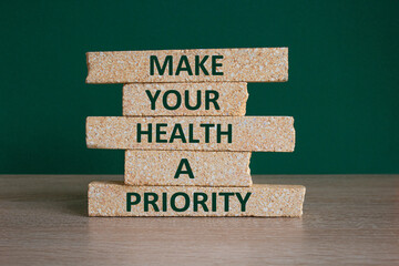 Concept green words Make your health a priority on brick blocks on a beautiful green background. Psychological mental health concept. - obrazy, fototapety, plakaty