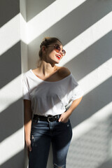 Portrait of laughing young woman with red lips and sunglasses