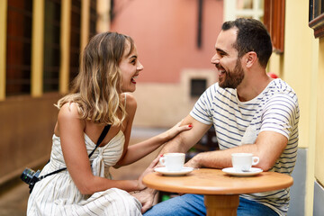 Spain, Andalusia, Malaga, happy couple having a coffee in an alley