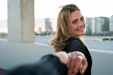 Spain, Barcelona, portrait of happy young woman holding hand