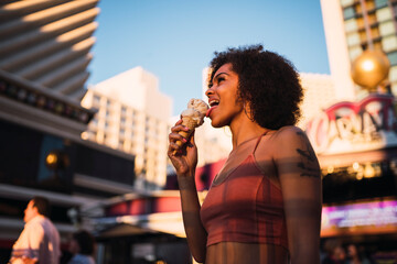 USA, Nevada, Las Vegas, happy young woman eating ice cream in the city