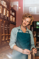 Coffee roaster in his shop packing bag of coffee