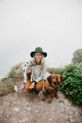 Young woman with two dogs on viewpoint