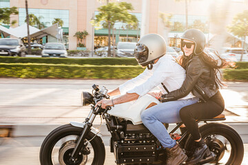 Couple riding motorbike in the city