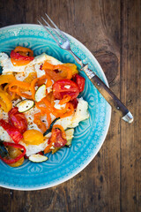 Baked goat cheese with paprika, tomato and zucchini