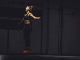 Young woman skipping rope