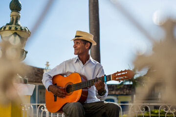Cuba, Trinidad, man playing guitar on the street