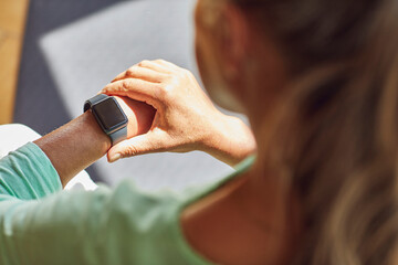 Woman checking the time in living room