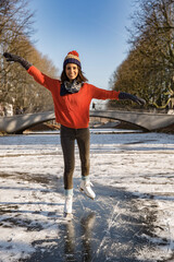 Woman ice skating on canal