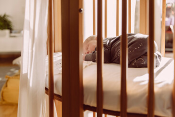 Newborn sleeping in his crib at home