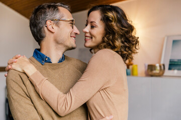 Happy affectionate couple at home - obrazy, fototapety, plakaty