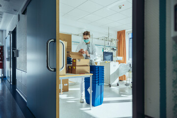 Doctor checking storage in hospital