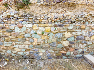Background. An ancient stone wall made of stones