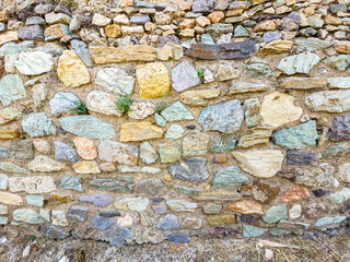 Background. An ancient stone wall made of stones