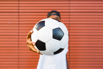 Man's hand holding soccer, close-up