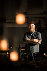 Proud hobby chef standing in his kitchen, with arms crossed