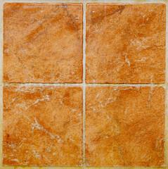 Detailed seamless texture of ceramic square tiles in brown color