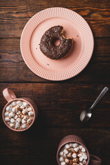 Chocolate Donut with a Bite and Mugs of Hot Chocolate