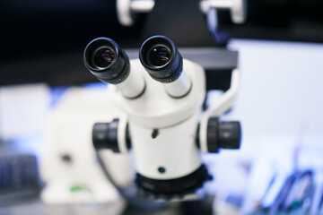 Fototapeta na wymiar Close-up of white microscope at illuminated laboratory